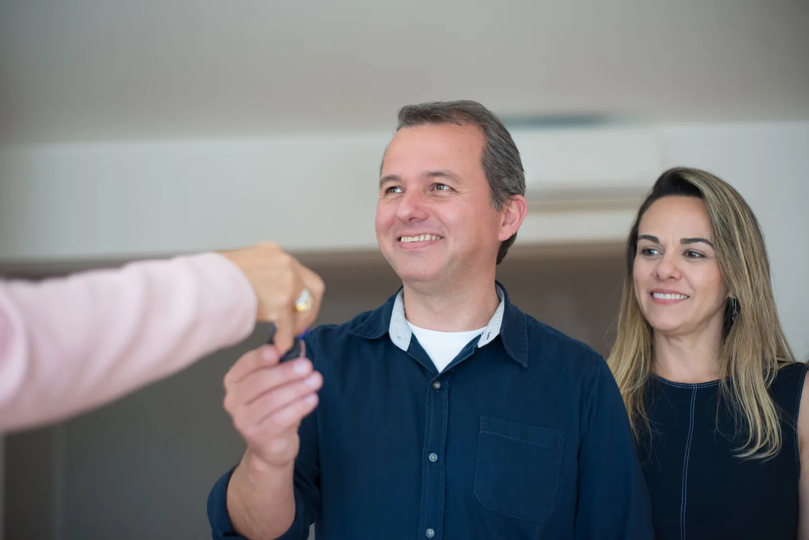 A family receiving the keys to their new home